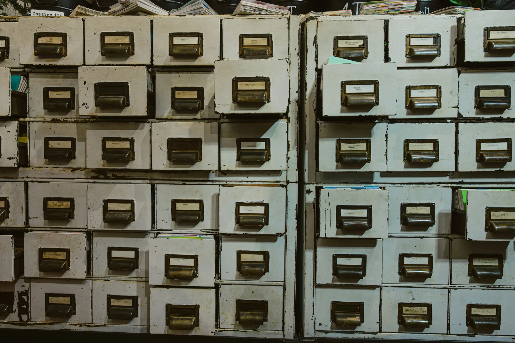 A wall of card-index drawers, each with a written label.